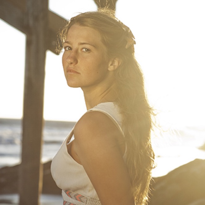 Woman illuminated by warm window light during an artistic professional portrait photography session by Kay Fritze of Fritze Media