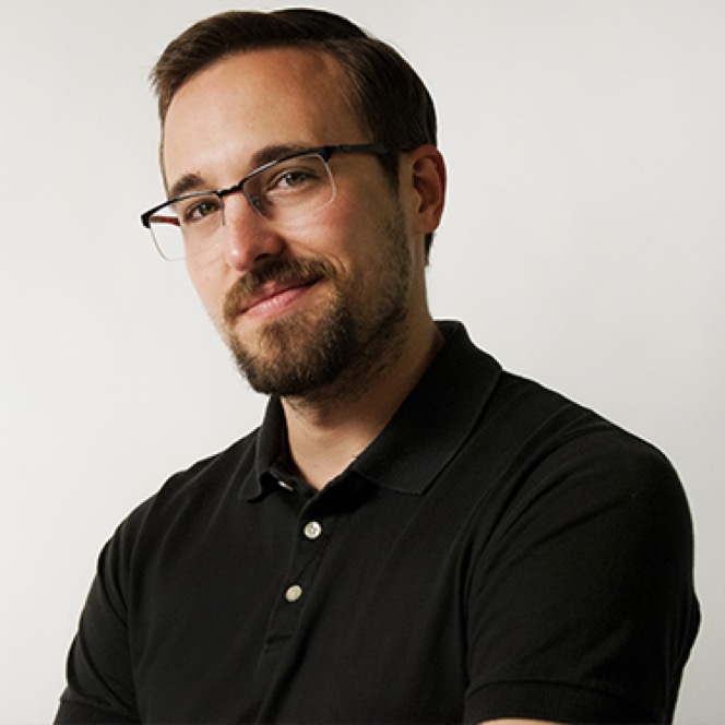 Man wearing glasses photographed against a neutral background during a professional headshot and portrait session by Kay Fritze of Fritze Media