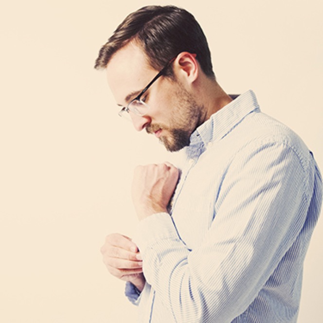 Man wearing glasses and a light shirt photographed in profile during a professional business portrait session by Kay Fritze of Fritze Media