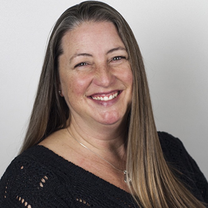 Woman smiling against a clean white background during a professional headshot and portrait photography session by Kay Fritze of Fritze Media